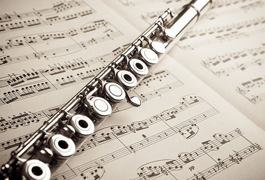 Flute on top of sheet of music